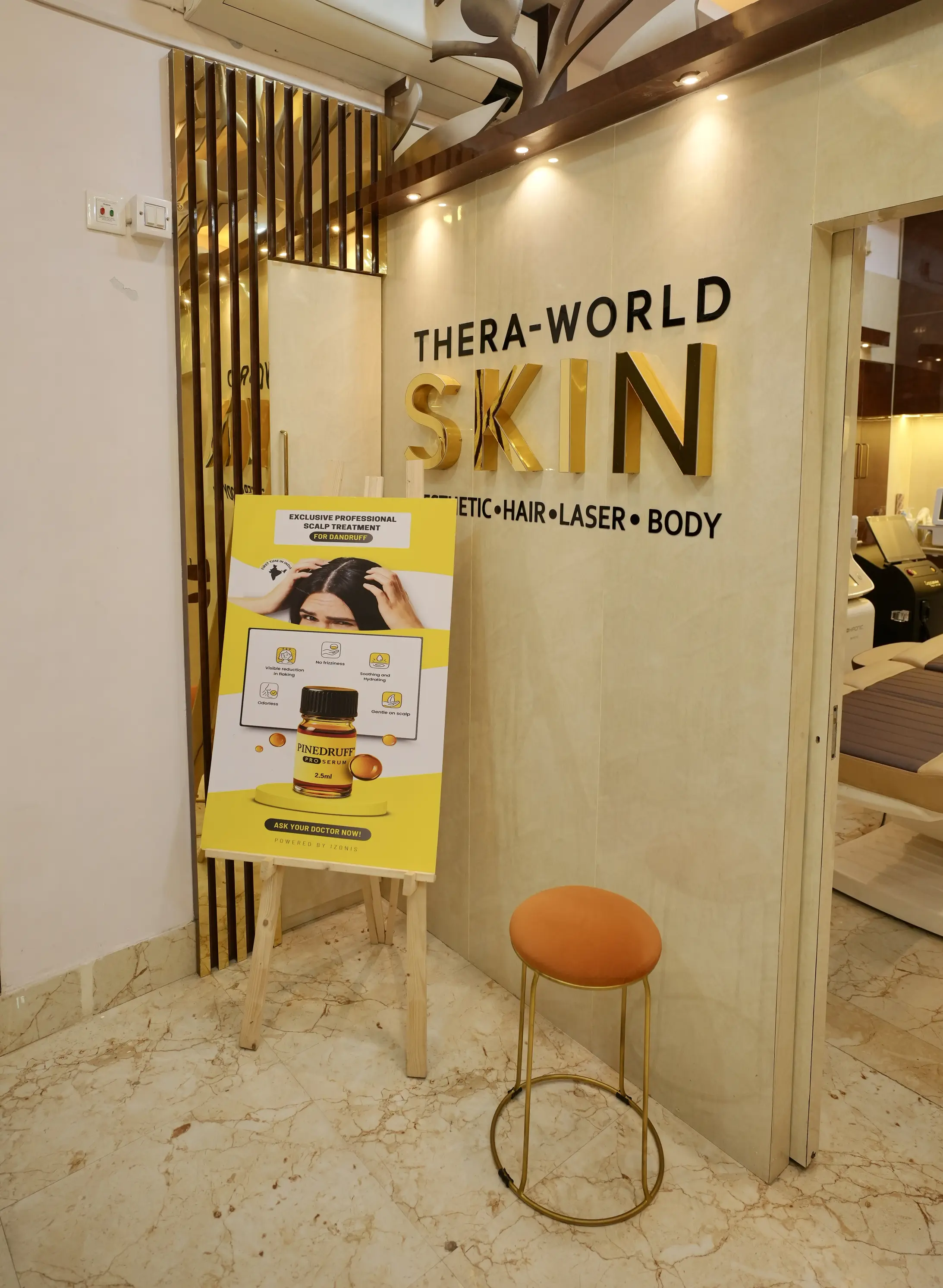 Thera-World Skin interior branding wall with gold lettering